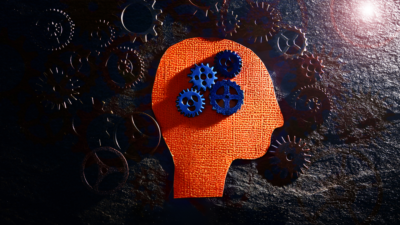 A silhouette of a head with gears surrounding it.